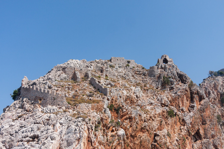 View from sea of ancient walls and remains fo ancient monastery located on cape Jilvarda in Alanya castle rock shot on sunny dayの写真素材