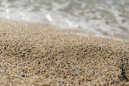 Beautiful sand at Cleopatra beach in Alanya turkey with sand in center of image in sharp focus and blurred wave and sand on foreground and background.の写真素材