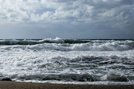 seascape showing powerful waves shot on cloudy day landscape layoutの写真素材