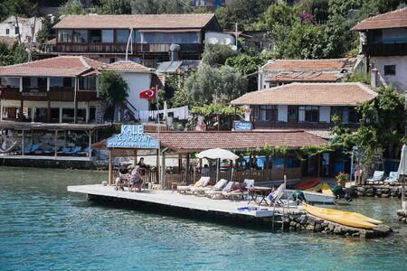 SIMENA, TURKEY - MAY 20 : Kalekoy Simena settlement in Uchagiz bay of Turkey near sunken city of Kekova with stonebuilt houses mixed with ancient ruins and Lycian tombs and castle on top of hill in 2016のeditorial素材