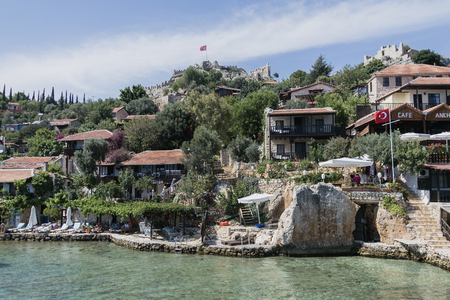 SIMENA, TURKEY - MAY 20 : Kalekoy Simena settlement in Uchagiz bay of Turkey near sunken city of Kekova with stonebuilt houses mixed with ancient ruins and Lycian tombs and castle on top of hill 2016のeditorial素材
