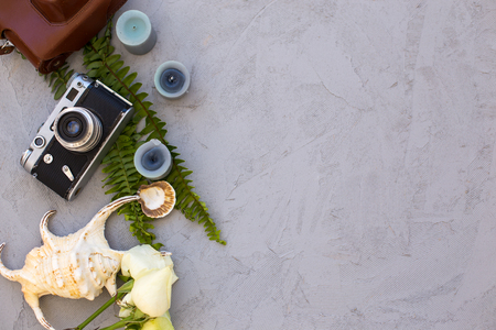 Topview shot of flatlay with vintage film camera,  large seashell, roses and candles. Horizontal composition, copy space.の写真素材