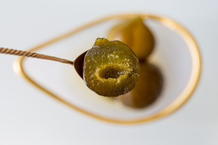 Upper view shot of a fig jam in golden tea spoon. Selective focus.の写真素材
