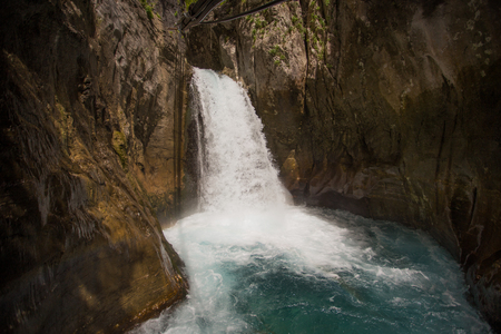 Horizontal shot of a powerfull waterfall in a mountain canyon.の写真素材