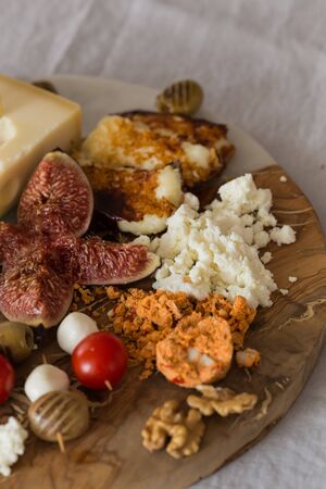 fragment of the cheese plate with figes, olives, fried cheeseの写真素材
