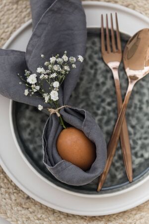 Easter table setting with linen napkin and ceramic tablewareの写真素材