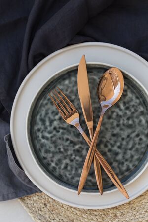 Table styling with black and white stoneware and copper color cuの写真素材