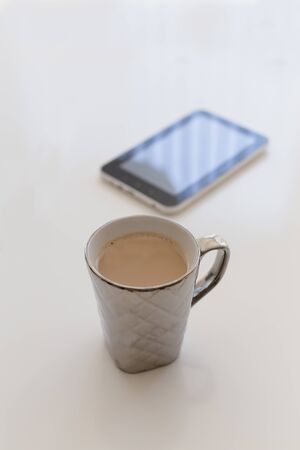 Home office mockup. A cup of coffee and black tabletの写真素材