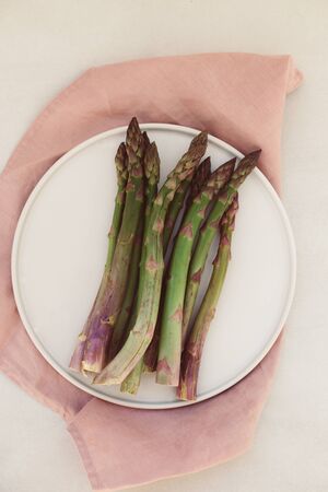 topview shot of asparagus on white plateの写真素材