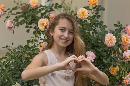 Spring portrait of a girl with long blonde hair posing in frontの写真素材