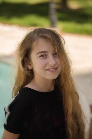 Portrait of a smiling teenager girl with long blonde hairの写真素材