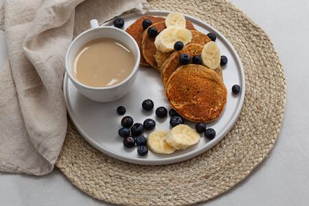 Breakfast platter with coffee latte and oatmeal pancakesの写真素材