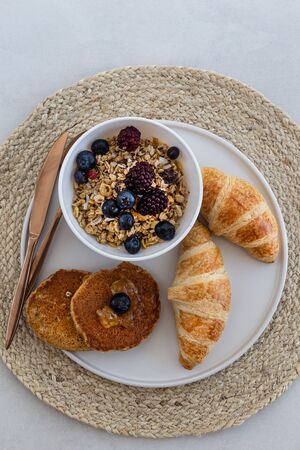 Healthy breakfast concept. Granola with berries, croissants andの写真素材