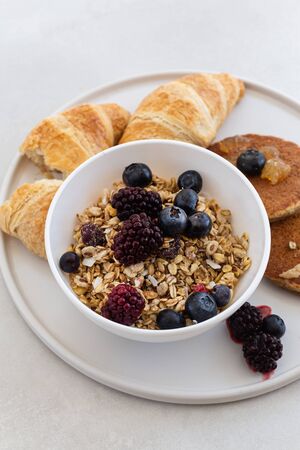 Healthy breakfast concept. Granola with berries and croissants.の写真素材