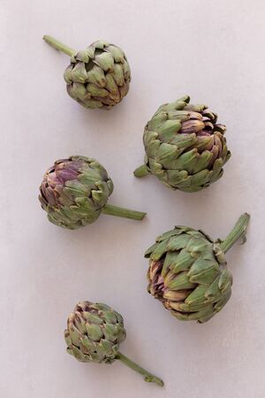 Topview image of artichokes on a light gray background.の写真素材