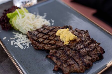 Delicious grilled steak on a ceramic plateの写真素材