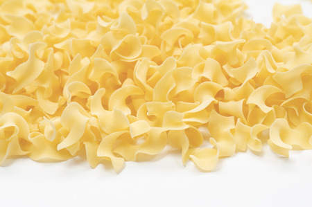 pasta tagliatelle girate on a white background. Selective focus