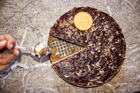 Eating a delicious pie of chocolate by the spoonの写真素材