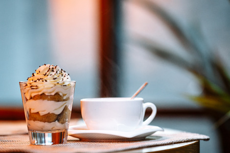 tea cup and saucer and dessert in a glass