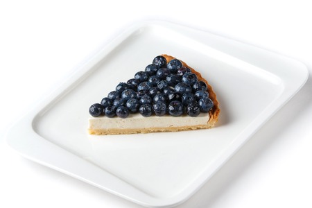 piece of blueberry pie in a white rectangular plate on an isolated white background