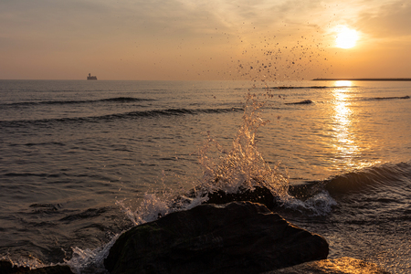stones in the sea on the background of sunriseの写真素材