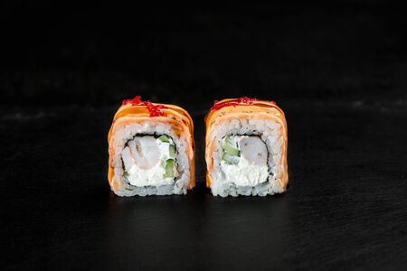 pair of sushi rolls close-up on a dark backgroundの写真素材