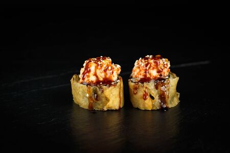 pair of sushi rolls segun close-up on a dark backgroundの写真素材