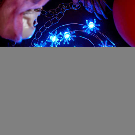 Halloween decoration garland of glowing spiders on a dark background