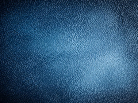 A close up shot showcasing the intricate texture of deep blue leather The fine grain pattern provides a detailed surface design ideal for use as a background or overlay The materials subtle color variations add depth and visual interest A classic and sophisticated design elementの素材