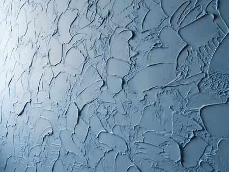 Close up shot of a textured blue wall The texture is made of thick layers of paint or plaster applied in a random pattern The wall has a slightly rough feel and the blue color is light and soothing The surface is ideal for use as a background in creative projects and graphic designsの素材