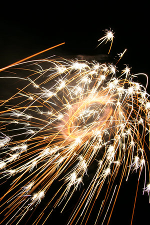 Japanese local tradition toy fireworks sparkling in front of black background.