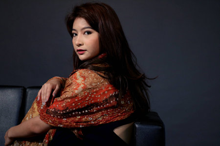 Women sits on sofa.(girl)の写真素材