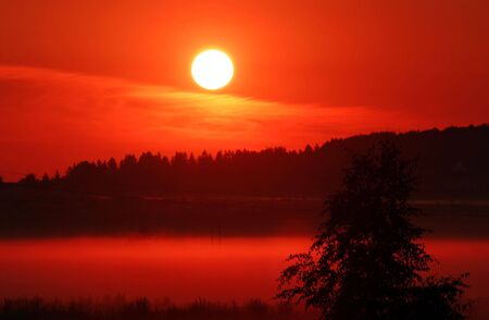 Red sunrise in the villageの写真素材
