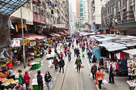 HONG KONG - FEBRUARY 21 : Street market in Central district on February 21, 2013 in Hong Kong. People buying and selling fruit, meat, fish and vegetable between buildings in Central district. のeditorial素材