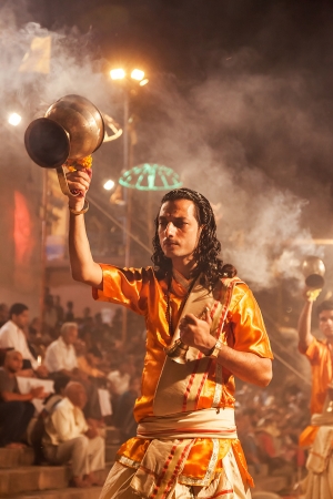 VARANASI, INDIA - APRIL 11: An unidentified Hindu priest performs religious Ganga Aarti ritual (fire puja) at Dashashwamedh Ghat on April 11, 2012 in Varanasi, Uttar Pradesh, Indiaのeditorial素材