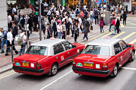 HONG KONG - MARCH 19: Taxi and unidentified people near Wan Chai metro station on March, 19, 2013. Wan Chai metro station is a one of the most busy in HK.のeditorial素材