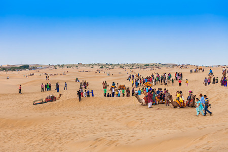 JAISALMER, INDIA - OCTOBER 13: Unidenfified people and camels in Thar desert on October 13, 2013, Jaisalmer, India.のeditorial素材