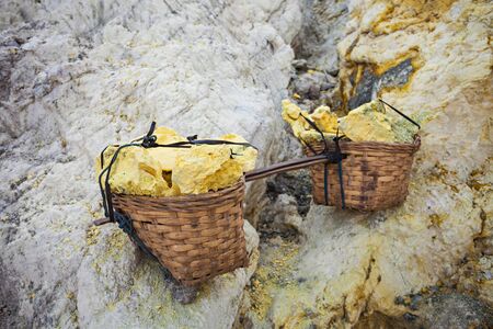 Basket with sulfur inside crater of Ijen volcano, East Java, Indonesiaの写真素材