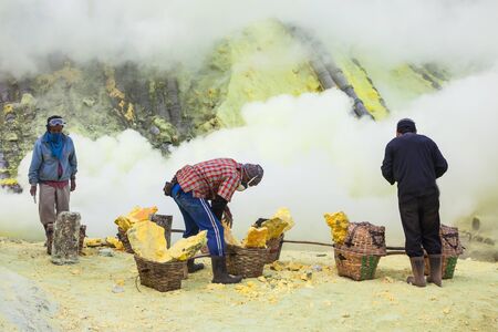 BANYUWANGI, INDONESIA - OCTOBER 27, 2014: Unidentified Sulfur miners inside crater Ijen volcano crater, Banyuwangi district, Indonesia.のeditorial素材
