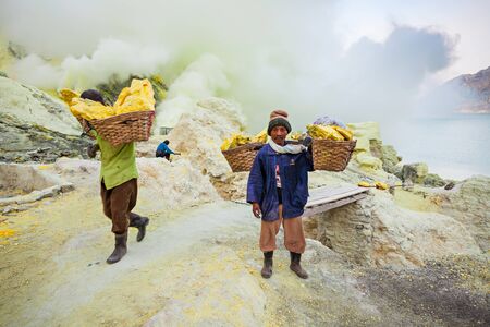 BANYUWANGI, INDONESIA - OCTOBER 27, 2014: Unidentified Sulfur miners inside crater Ijen volcano...