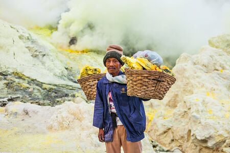 BANYUWANGI, INDONESIA - OCTOBER 27, 2014: Unidentified Sulfur miner inside crater of Ijen volcano, East Java, Indonesia.のeditorial素材