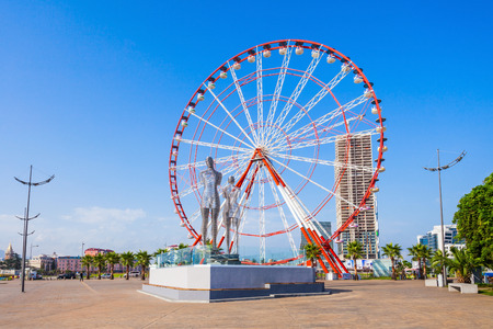 BATUMI, GEORGIA - SEPTEMBER 22, 2015: Moving metal sculpture "Ali and Nino" (old name "Man and Woman") by Tamara Kvesitadze and Ferris wheel in Batumi, Georgia.のeditorial素材