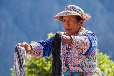 CABANACONDE, PERU - MAY 13, 2015: Unidentified women selling souvenirs at Cruz Del Condor viewpoint.のeditorial素材
