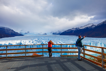 EL CALAFATE, ARGENTINA - APRIL 21, 2016: Tourists near the Perito Moreno Glacier, Argentina. Perito Moreno is a glacier located in the Los Glaciares National Park in Patagonia, Argentina.のeditorial素材