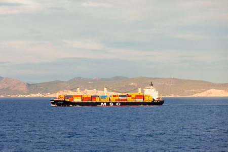 SYROS ISLAND, GREECE - OCTOBER 21, 2016: Container ship or cargo ship in the Aegian sea in Greece.の写真素材