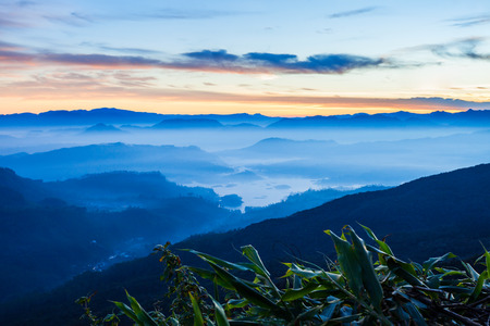 Foggy mountains aerial panoramic view from the Adams Peak or Sri Pada on sunrise. Adams Peak is a tall and holy buddhist mountain in Sri Lanka.の写真素材