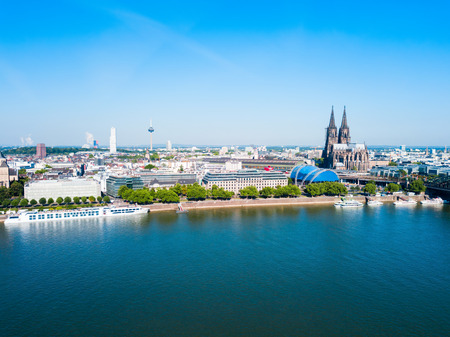 Cologne Cathedral and Hohenzollern Bridge through Rhine river in Cologne, Germanyの写真素材