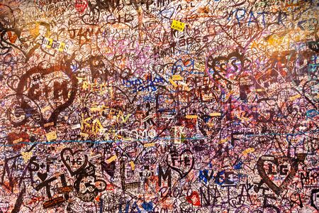VERONA, ITALY - APRIL 16, 2019: Wall covered with romantic love messages in Juliets House in Verona,...