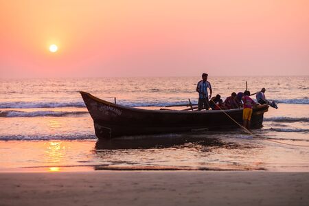 GOA, INDIA - NOVEMBER 18, 2011: Fishermen coming back from the sea with catch in Goa, Indiaのeditorial素材