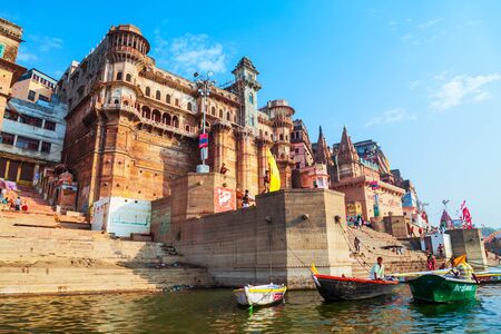 VARANASI, INDIA - APRIL 12, 2012: Colorful boats and Ganges river bank in Varanasi city in Indiaのeditorial素材